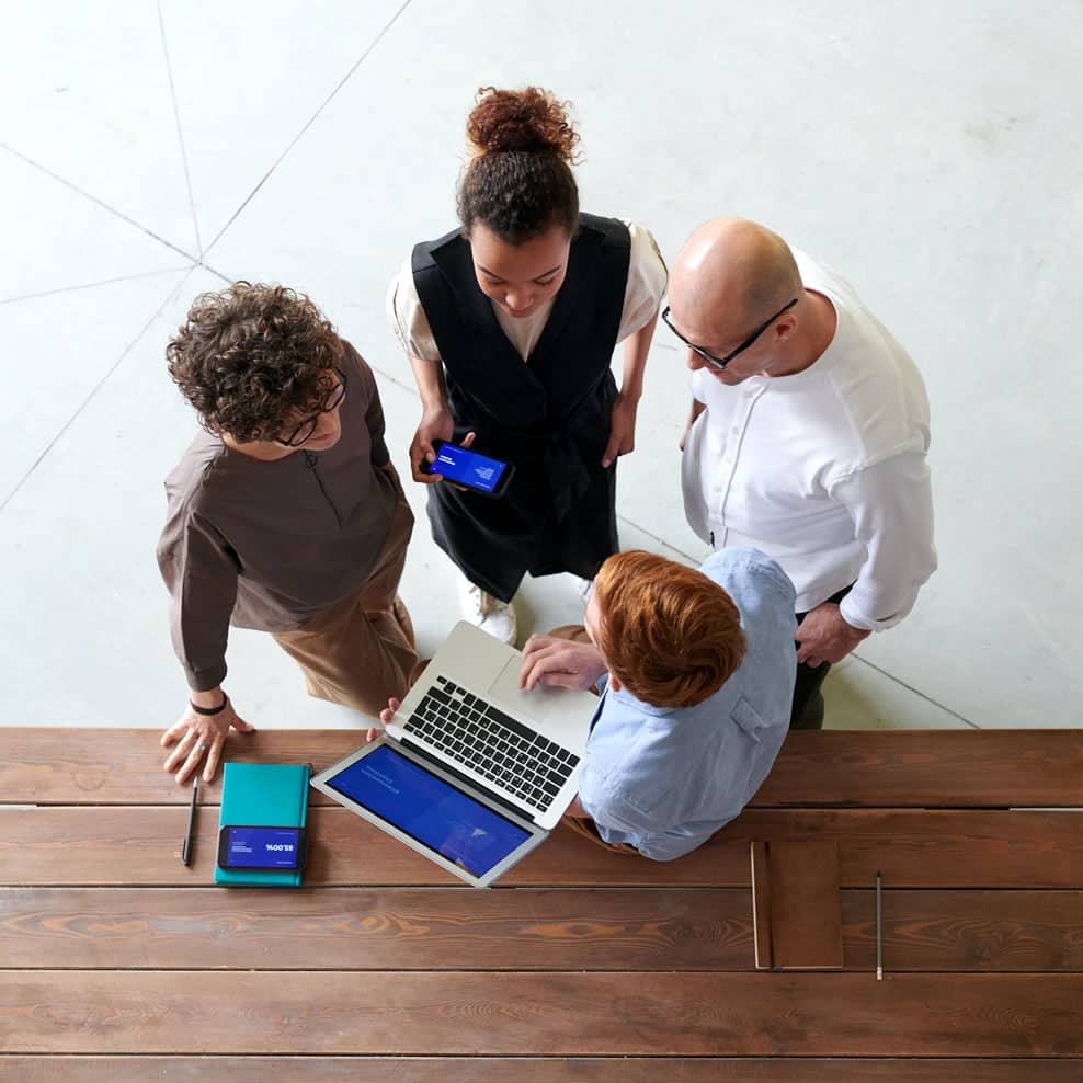 Image of 4 people standing. Image of them from above.